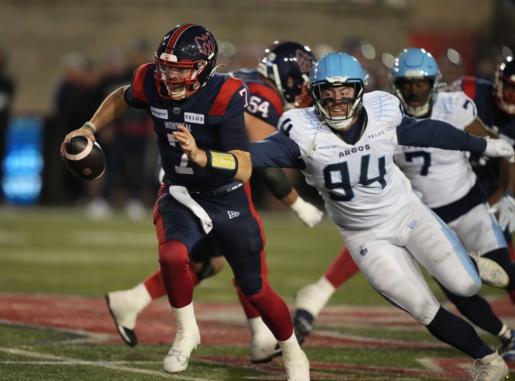 Montreal Alouettes quarterback Cody Fajardo (7) tries to get away from Toronto Argonauts defensive lineman Jake Ceresna (94) during third quarter CFL Eastern Conference Final football action Saturday, November 9, 2024 in Montreal. THE CANADIAN PRESS/Christinne Muschi.