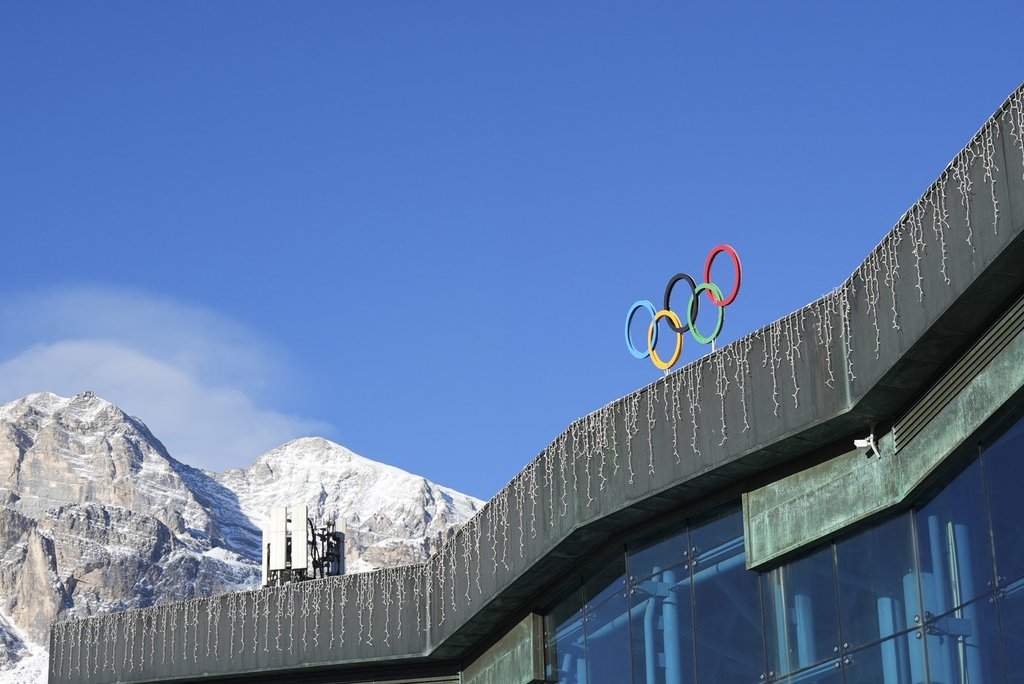 The Olympic rings adorn the Stadio Olimpico del Ghiaccio, which will be called Cortina Curling Olympic Stadium, venue for the curling discipline at the Milan Cortina 2026 Winter Olympics, in Cortina d'Ampezzo, Italy on Jan.16, 2025. (AP Photo/Giovanni Auletta).