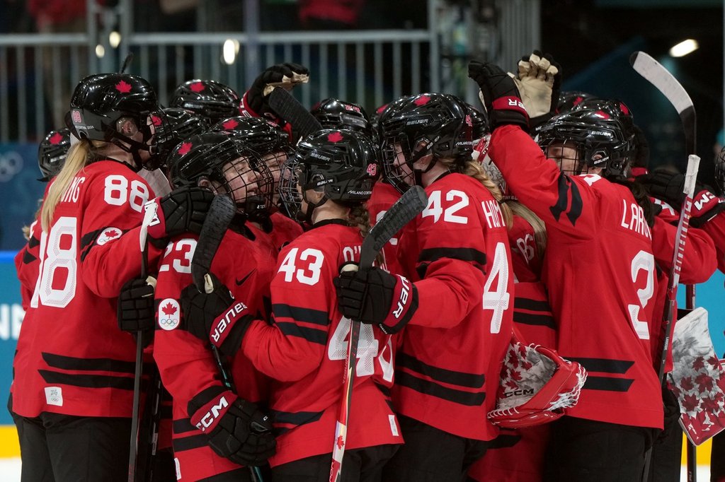 Canada players celebrate the team's 5-1 win over Germany following the third period of a women's hockey quarterfinal game at the 2026 Winter Olympics, in Milan, Saturday, Feb. 14, 2026. THE CANADIAN PRESS/Darryl Dyck.