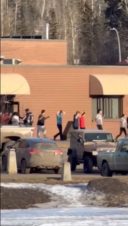 A total of 10 people are dead after a pair of shootings Tuesday in the tiny community of Tumbler Ridge in B.C.'s Peace region. The community went into a lockdown that lasted several hours, after police were called about an active shooter at Tumbler Ridge Secondary School. In this still from a video provided to The Associated Press from the scene, students are seen being escorted out of the school with their hands in the air.
THE CANADIAN PRESS/AP-Jordon Kosik.