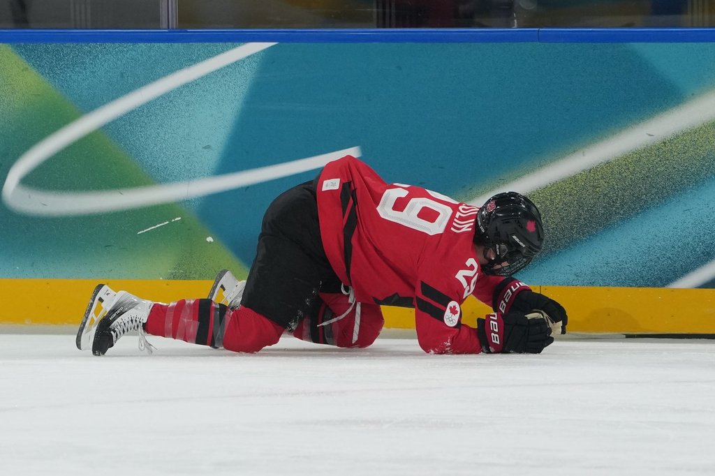 Canada's Marie-Philip Poulin (29) is down on the ice in the first period against Czechia during a preliminary round match of women's ice hockey at the 2026 Winter Olympics, in Milan, Italy, Monday, Feb. 9, 2026. (AP Photo/Carolyn Kaster).