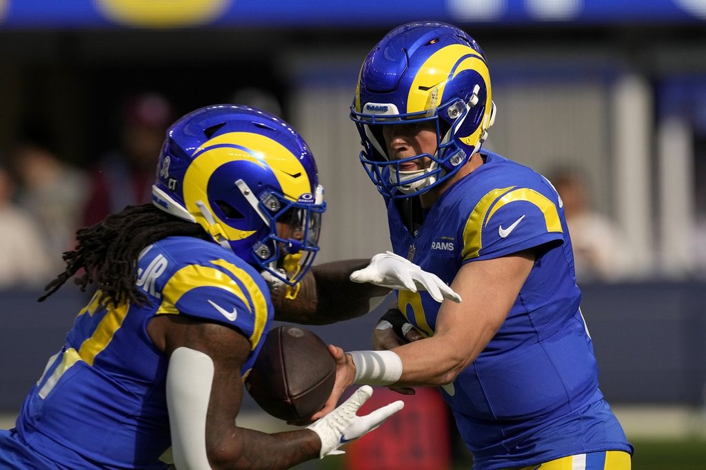 Los Angeles Rams quarterback Matthew Stafford (9) hands off to running back Darrell Henderson Jr. (27) during the first half of an NFL football game against the Seattle Seahawks Sunday, Nov. 19, 2023, in Inglewood, Calif. (AP Photo/Mark J. Terrill).