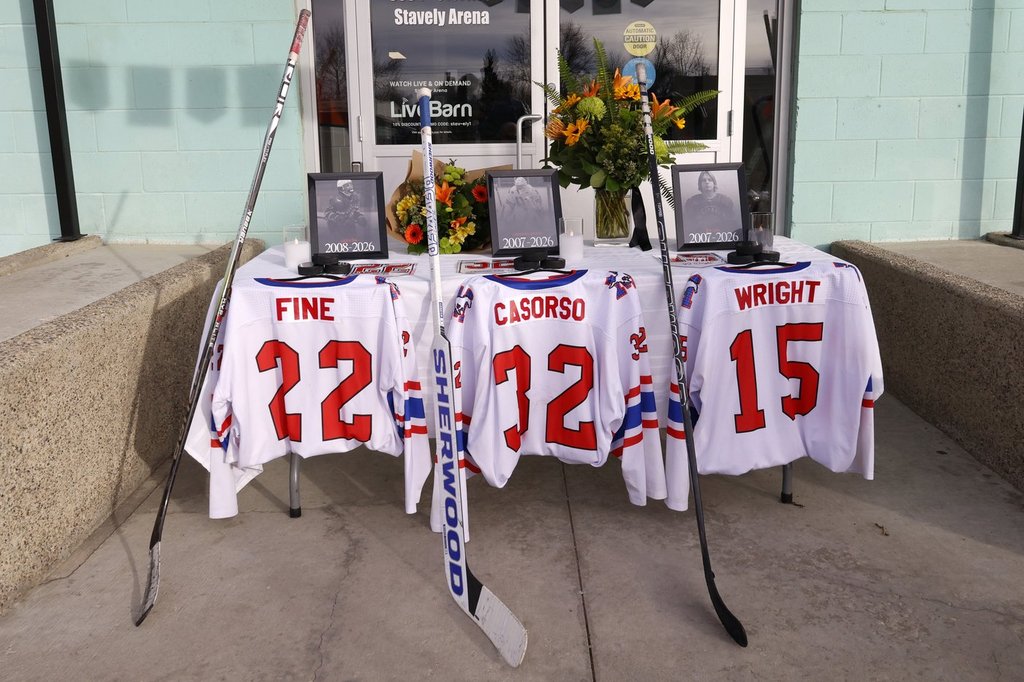Jerseys at a memorial outside main arena doors for three junior hockey players killed in a vehicle crash at Stavely, Alta., Feb. 3, 2026.