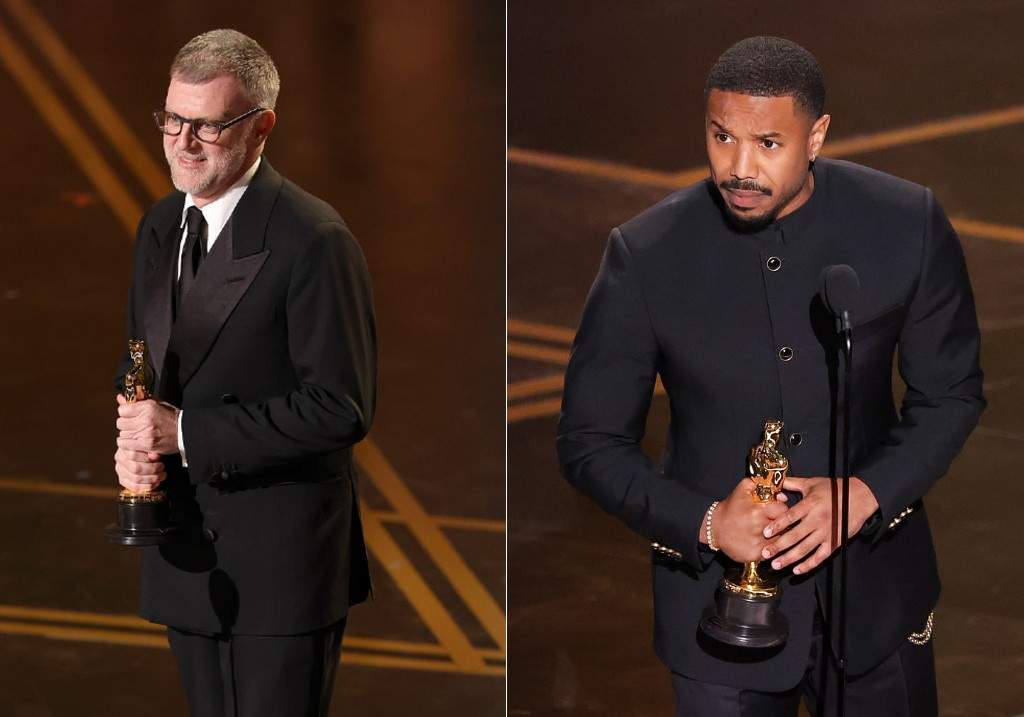 (L-R:) Paul Thomas Anderson accepts the Writing (Adapted Screenplay) award for One Battle After Another' and Michael B. Jordan at the 98th Annual Oscars held at Dolby Theatre on March 15, 2026 in Hollywood, California.