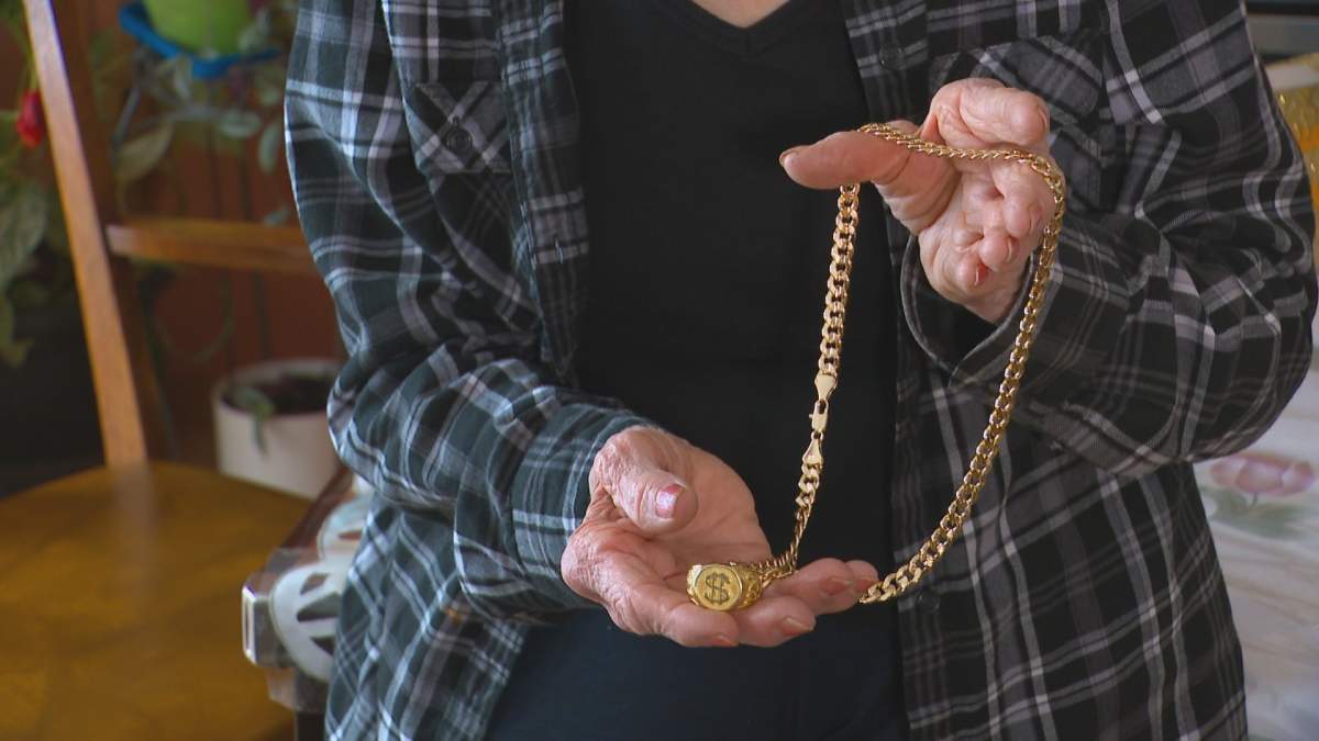 Peggy Duby holds the chain somebody put around her neck while she says her own necklace was being stolen.