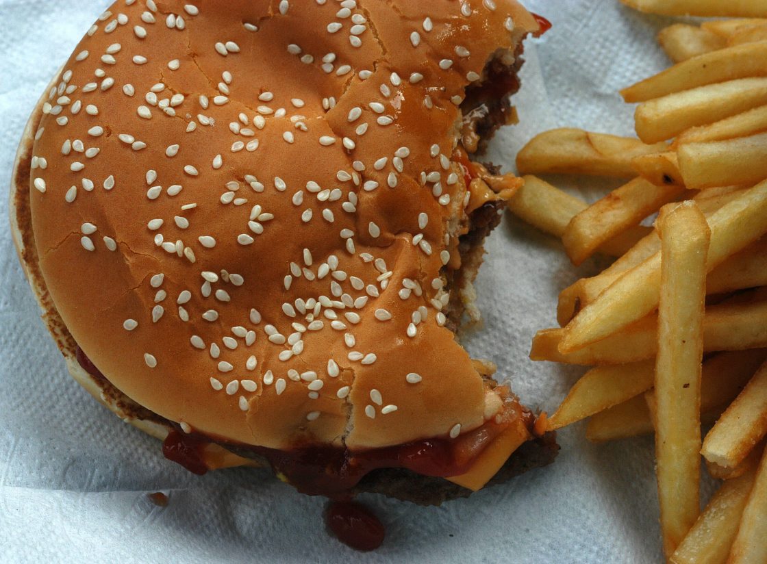 A burger and french fries, a standard fast food meal.