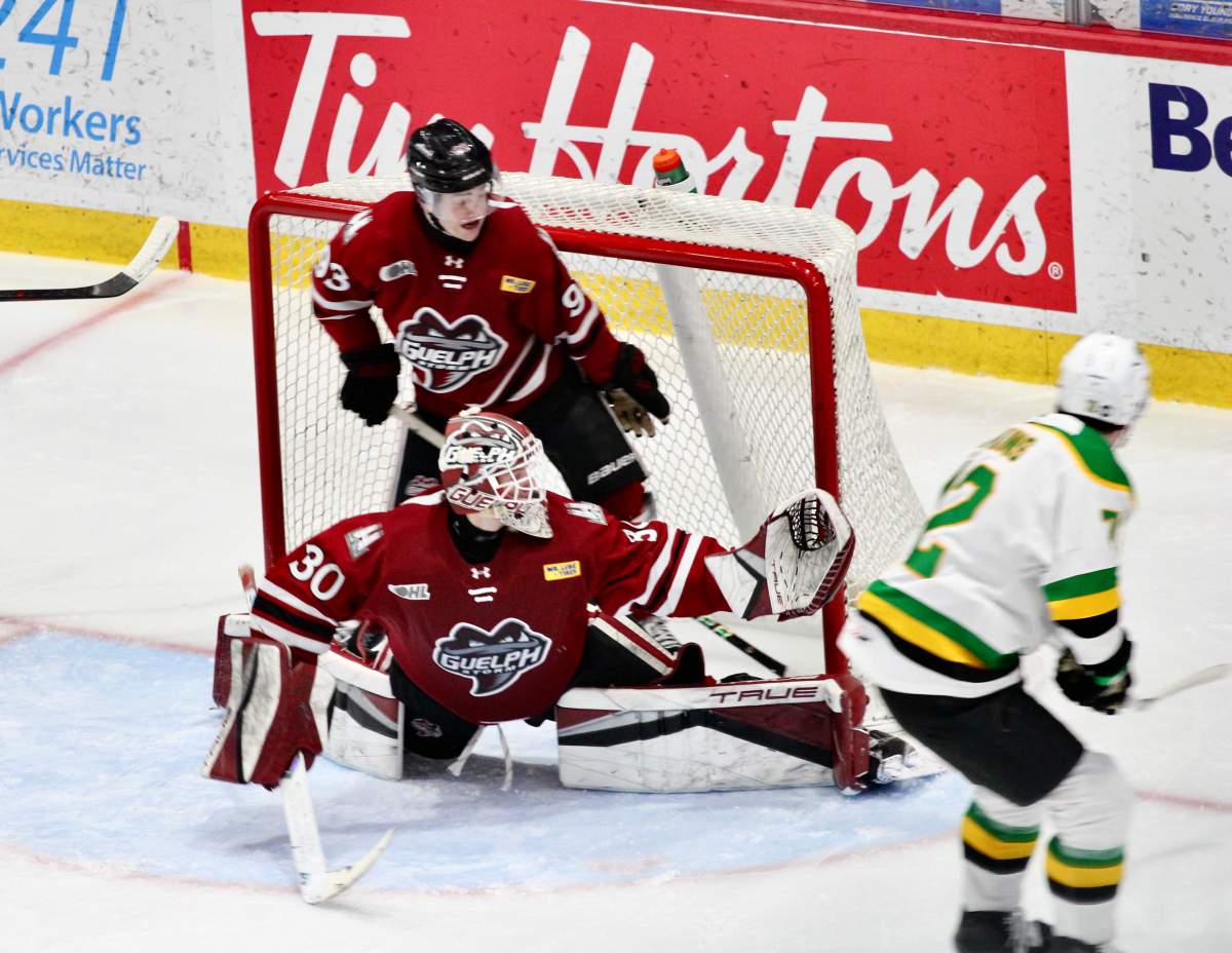 Kaeden Hawkins of the London Knights backhands a puck past Zach Jovanovski of the Guelph Storm to open the scoring in a 6-2 London victory at the Sleeman Centre on March 18, 2026.
