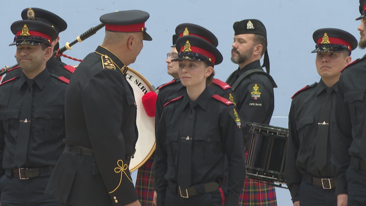 Lethbridge Police Service Chief Shahin Mehdizadeh inspects cadet Faith Dore during a graduation ceremony on March 5, 2026.
