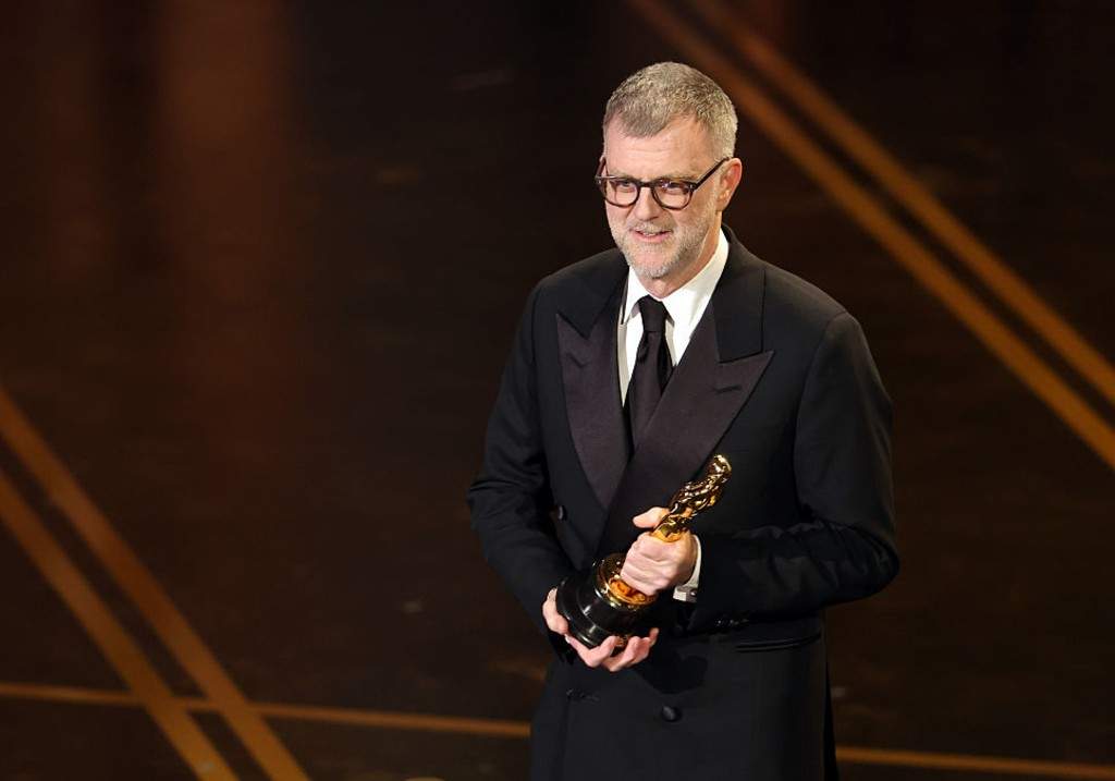 Paul Thomas Anderson accepts the Writing (Adapted Screenplay) award for 'One Battle After Another' onstage during the 98th Oscars at Dolby Theatre on March 15, 2026 in Hollywood, California.