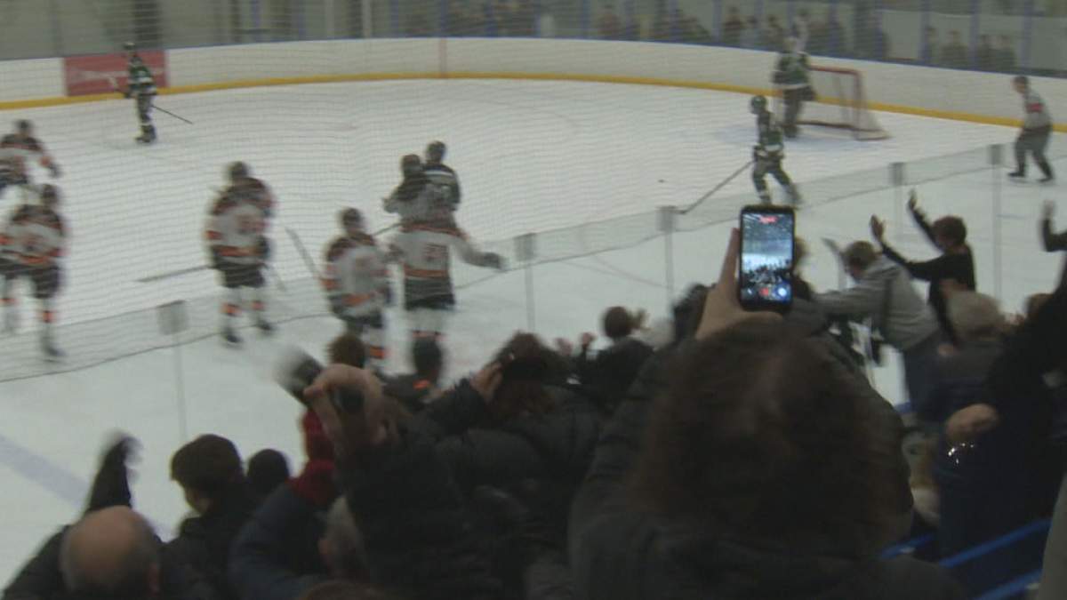 The Oak Park Raiders celebrate an overtime win in Game 2 of the WHSHL championship series.