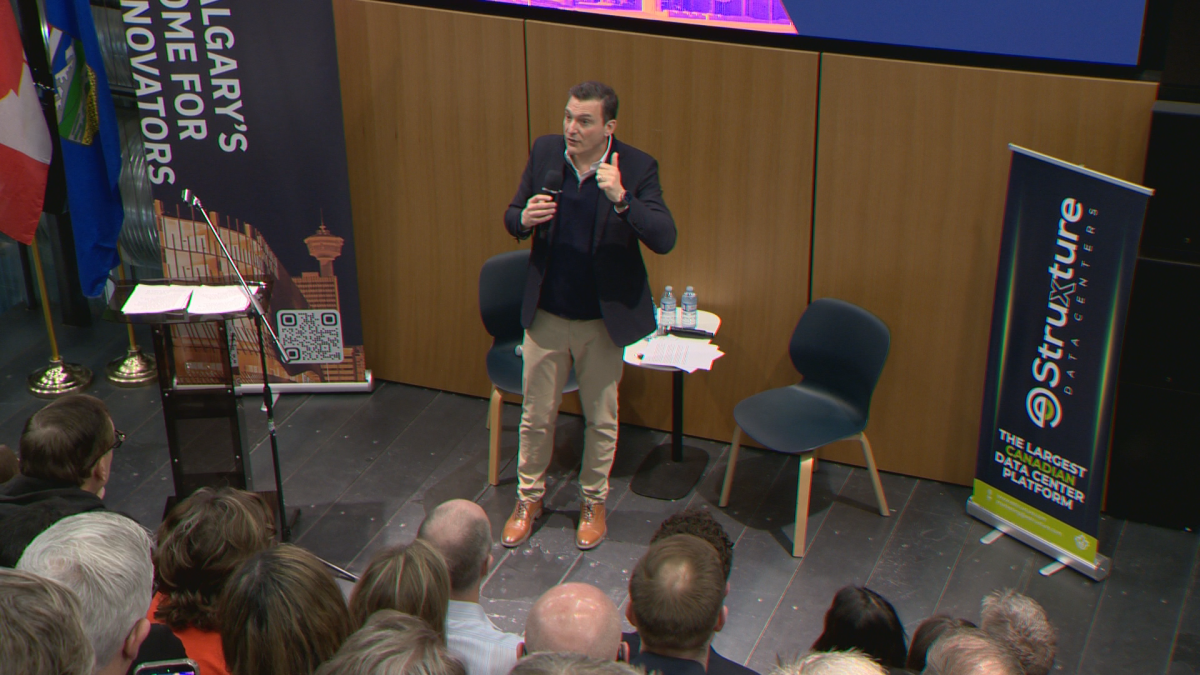 Evan Solomon addresses those in the AI industry at an event