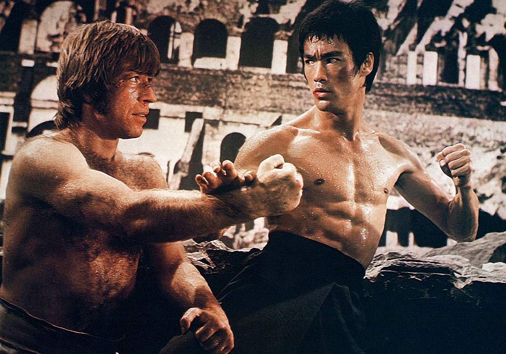 Bruce Lee and Chuck Norris bare-chested in martial arts stance from the 1972 film 'The Way of the Dragon'.