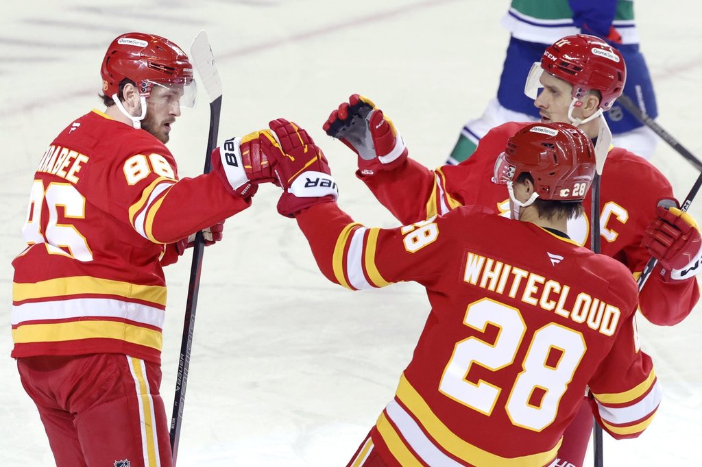 Flames ignite offence, burn Canucks 7-3