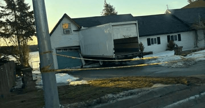 Large cube van crashes into Kingston home, officer struck during recovery
