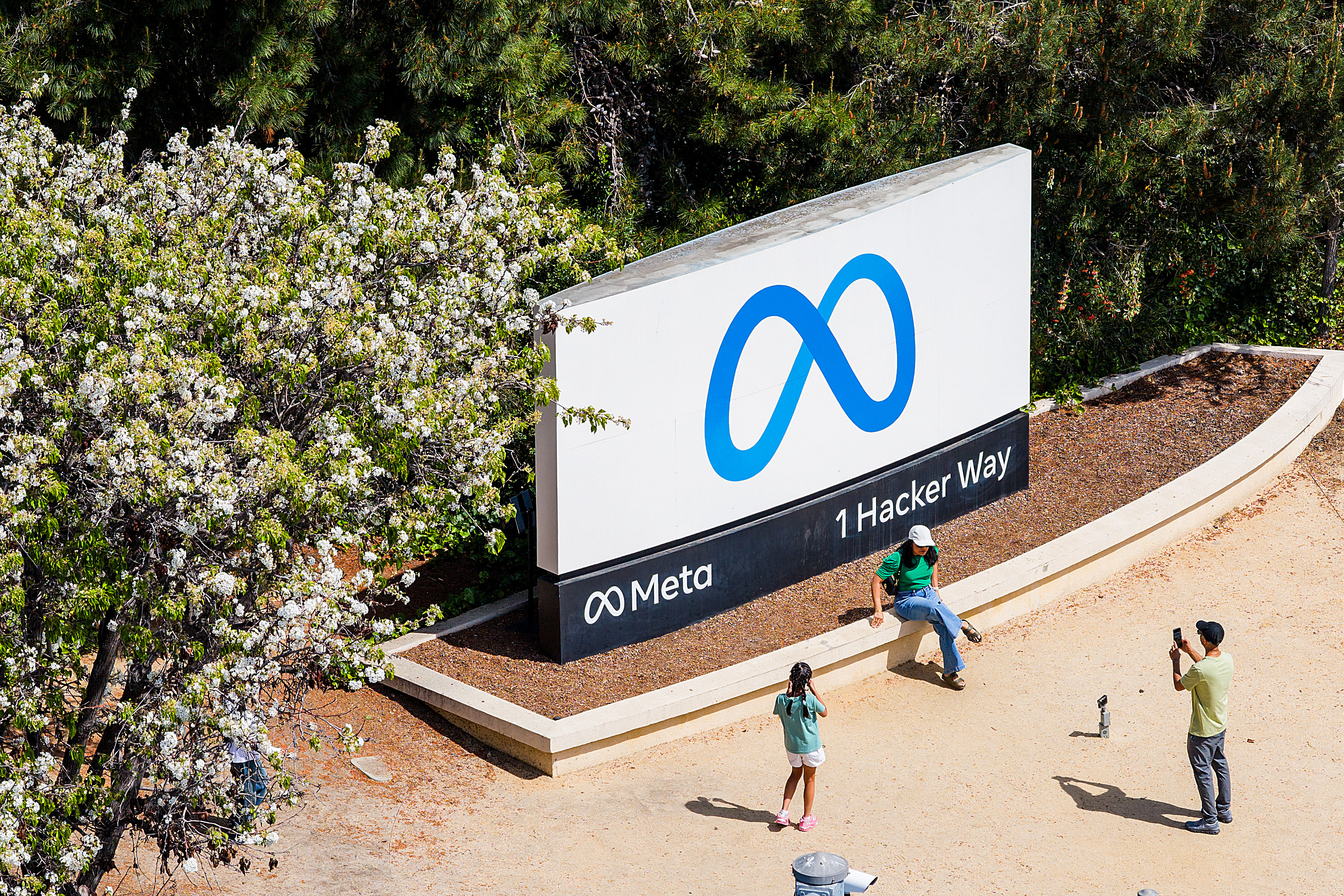 Visitors take photos at a sign outside Meta headquarters on Thursday, March 26, 2026, in Menlo Park, Calif.