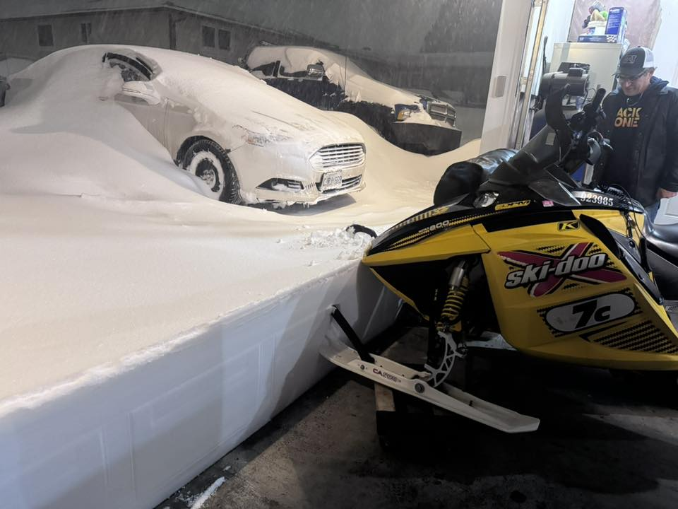A man in Sudbury, Ont., looks at snow that has piled outside his garage on March 15, 2026.