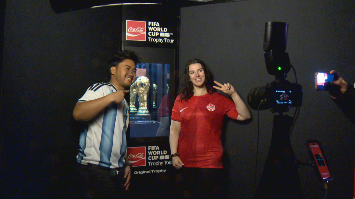 Fans pose with the FIFA World Cup trophy