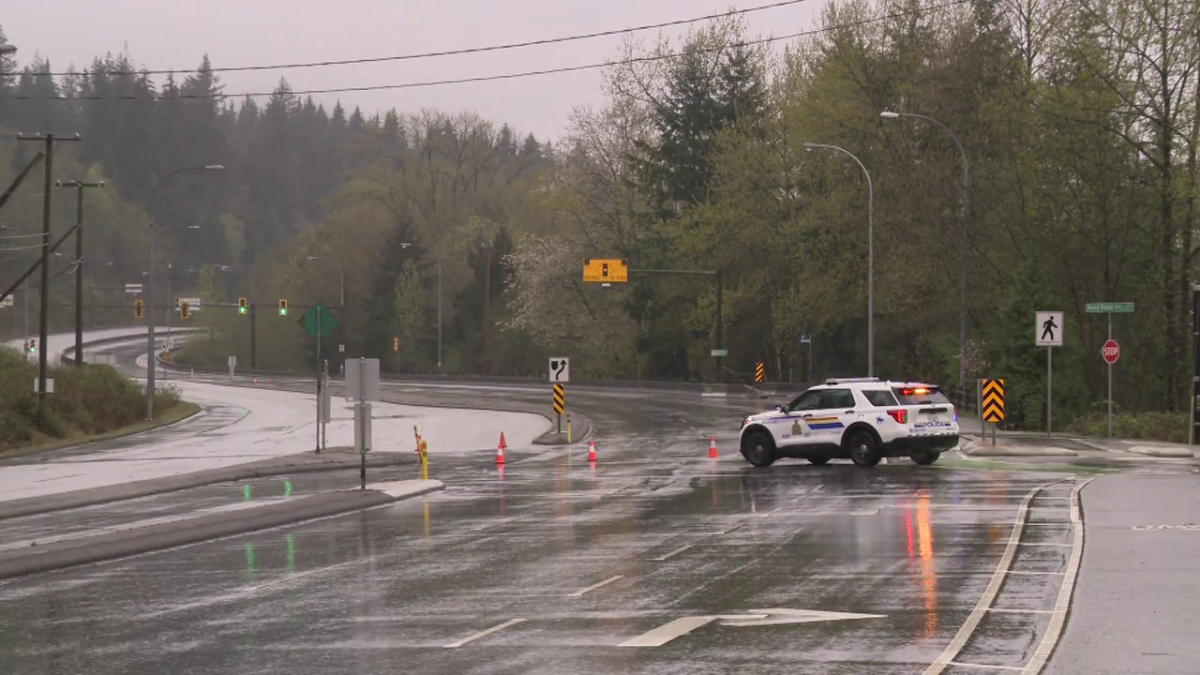 Burnaby RCMP on the Barnet Highway after a fiery crash on Tuesday morning.