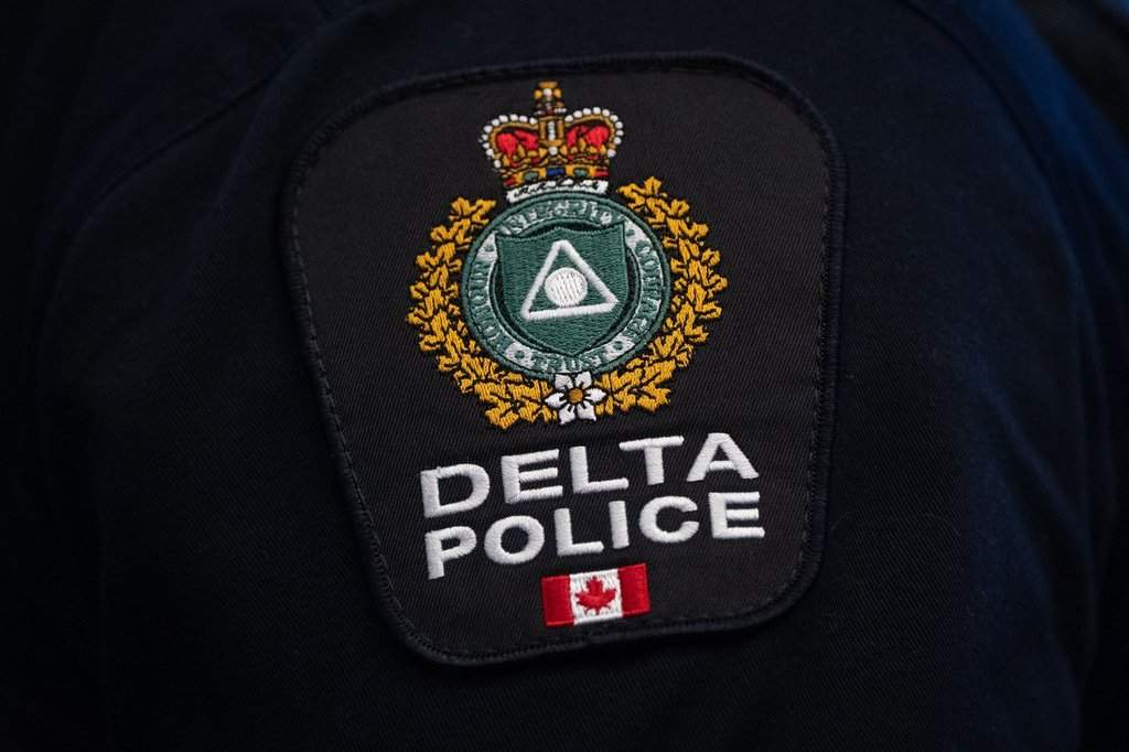 A Delta Police patch is worn by an officer at RCMP 'E' division headquarters in Surrey, B.C., on Feb. 19, 2026. THE CANADIAN PRESS/Ethan Cairns.