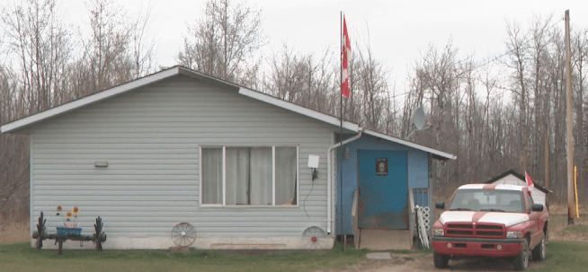 Canada flags fly from a home and a truck on Sturgeon Lake Cree Nation on May 6, 2026.