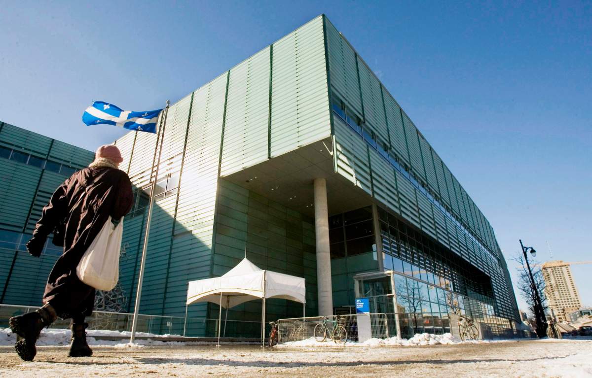 A man walks past the Grande Biblioteque library in Montreal on January 24, 2007. Montreal's Grande Bibliotheque has been dealing with a bedbug invasion for the past few weeks, but the library's executive director says she is confident it has a handle on the pest problem. Danielle Chagnon said today the situation was discovered about three weeks ago but is under control. 