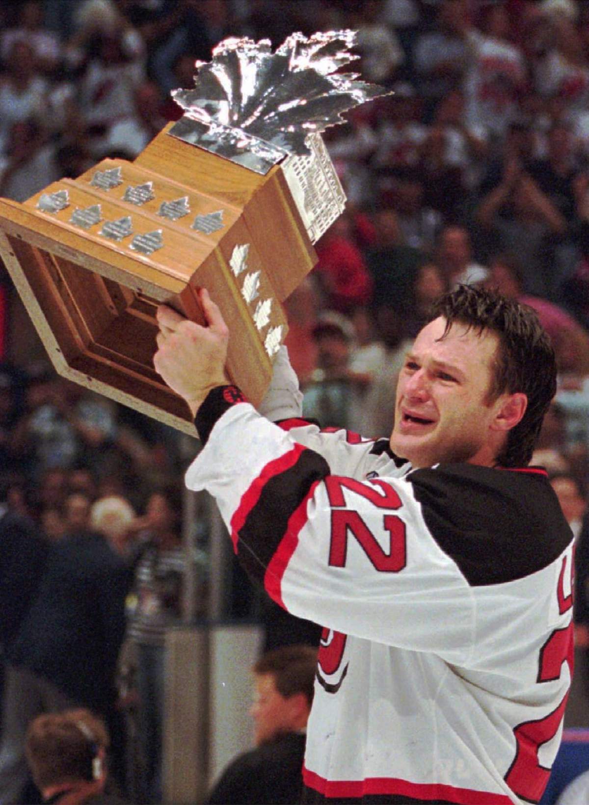 New Jersey Devils right wing Claude Lemieux holds the Conn Smythe Trophy after his team defeated the Detroit Red Wings in Game 4 of the Stanley Cup Finals to win the championship on June 24, 1995.