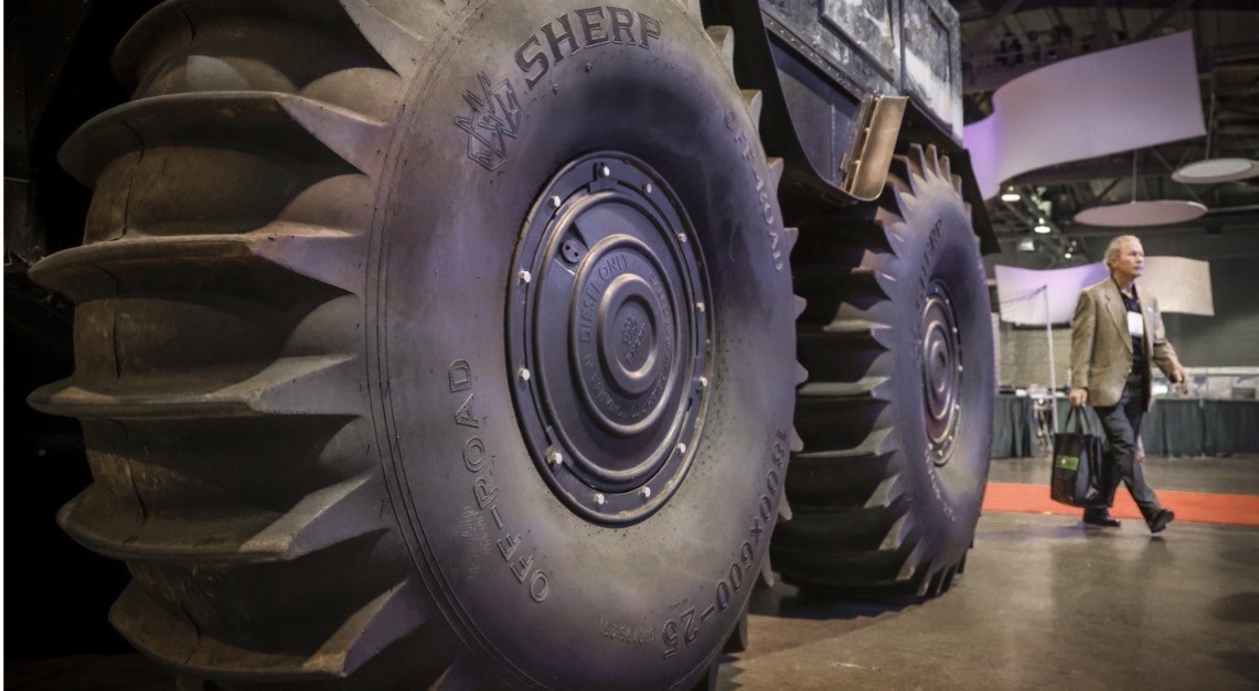 A delegate walks past an all-terrain vehicle at the Global Energy Show in Calgary on Tuesday.