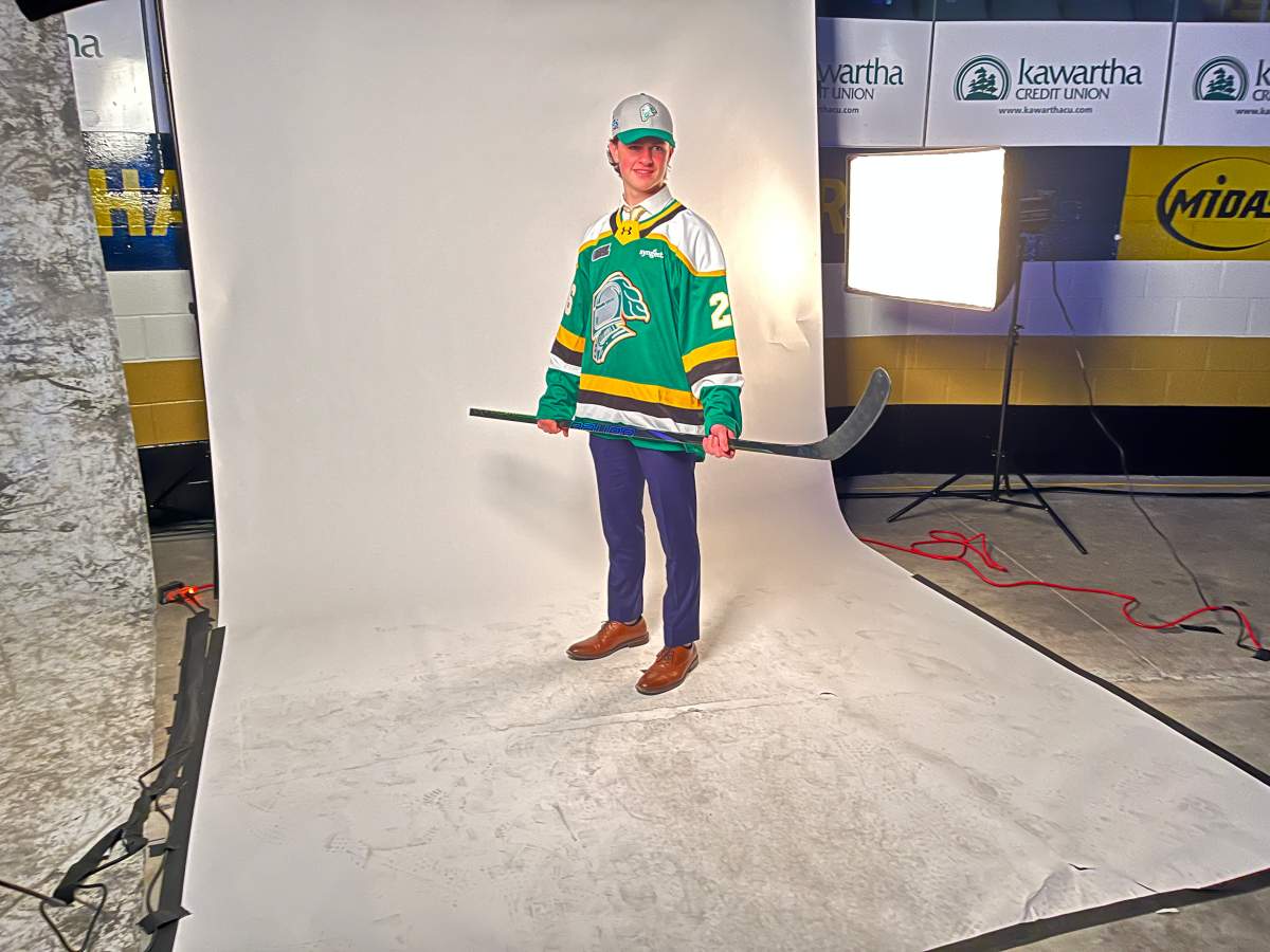 Graham Littlejohn from Wallacetown, Ont., poses for pictures after being chosen in the sixth round of the 2026 OHL Priority Selection.