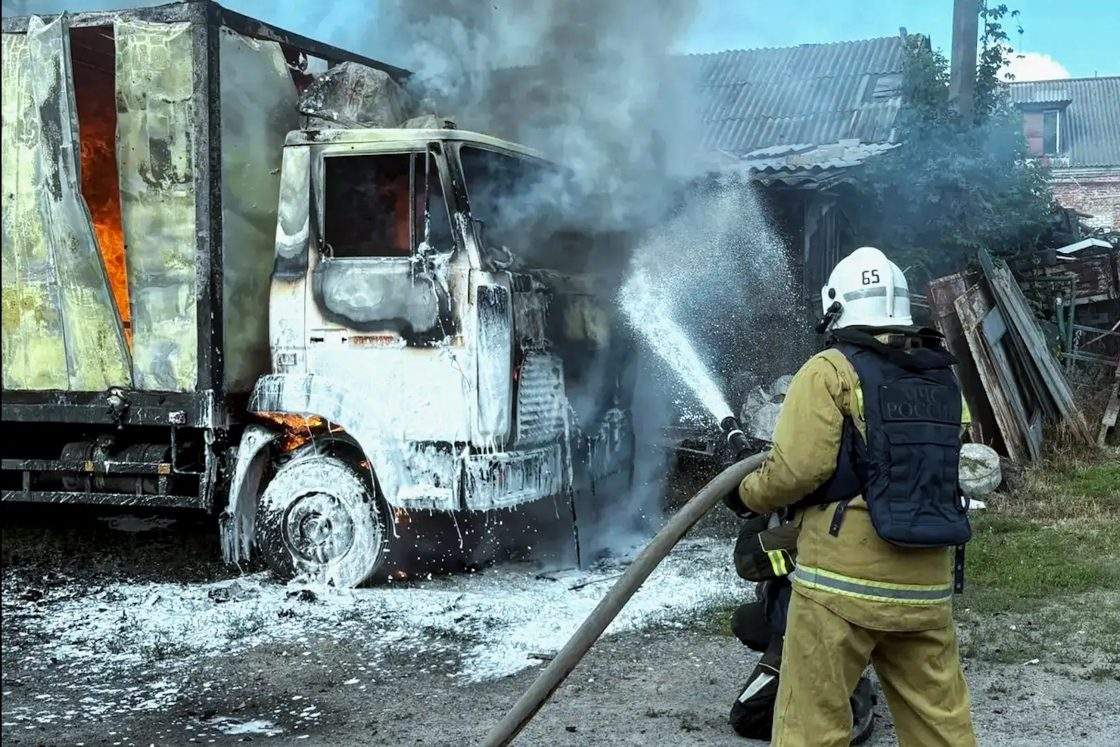 An emergency worker responds to a MAZ utility truck catching fire after a Ukrainian drone strike on Svatovo, northwest of Lugansk, no casualties reported.