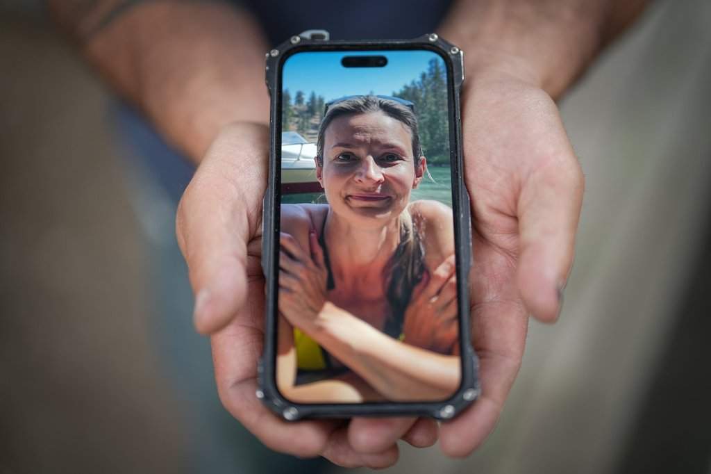 Jason Gaudreault, whose partner Tatjana Stefanski was found dead on April 14, 2024, after disappearing a day earlier, shows a photograph of her on his phone, in Lumby, B.C .