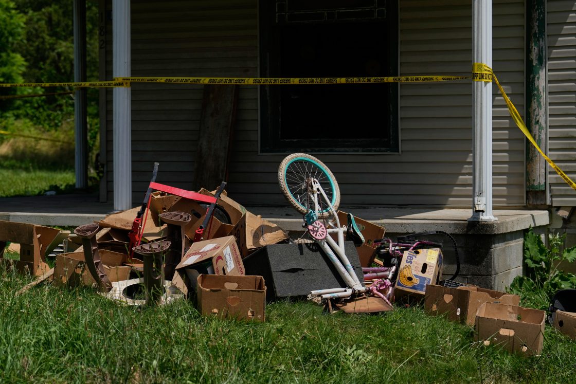 Police tape and debris are seen at a home where authorities say they removed 16 children and arrested four adults in Hamden, Ohio, July 1, 2026.				 
										
					 
					AP Photo/Carolyn Kaster