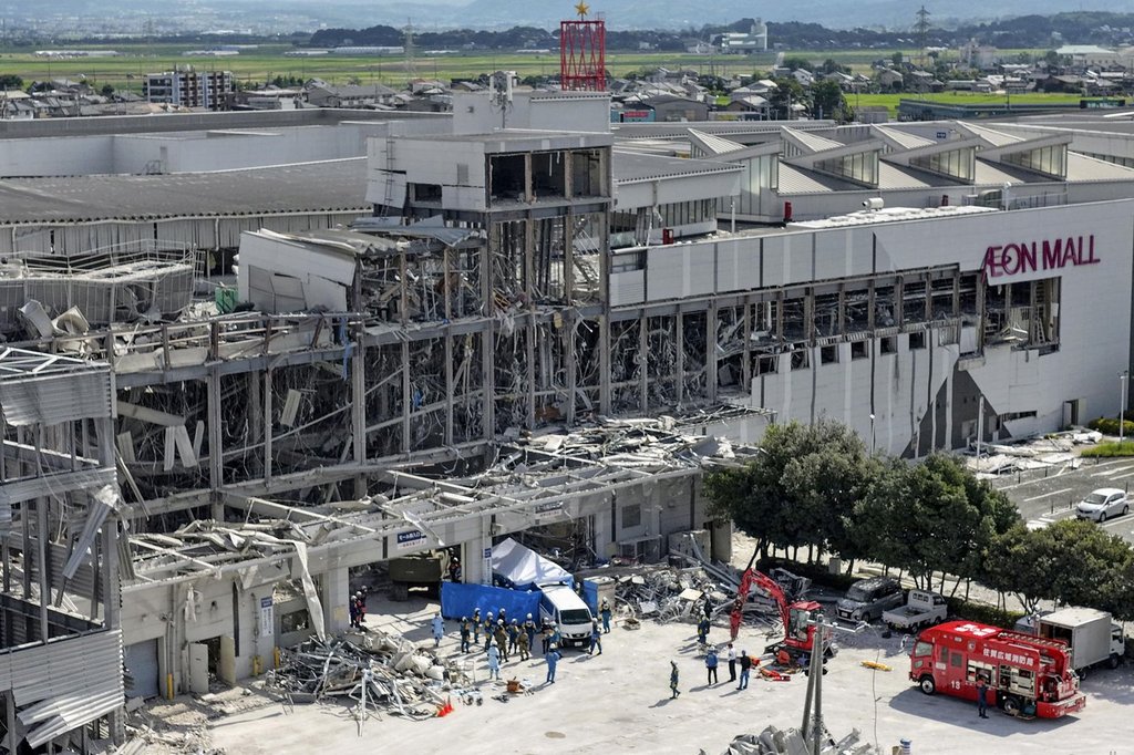 In this aerial image taken with a drone, responders work outside AEON Mall Kumamoto after an explosion occurred following an earthquake, in Kashima, Kumamoto Prefecture, southern Japan, Thursday, July 30, 2026.