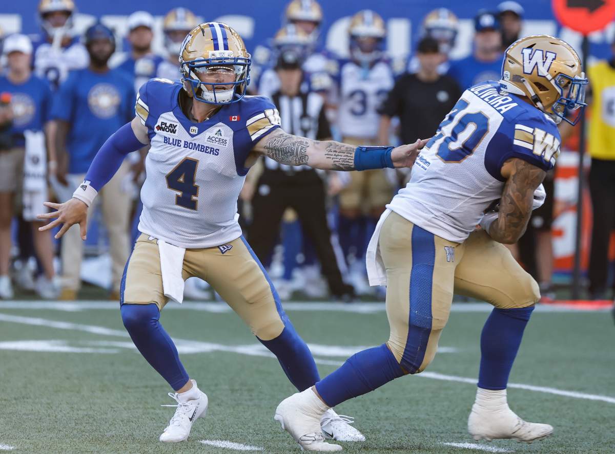 Winnipeg Blue Bombers quarterback Dru Brown (4) hands off to Brady Oliveira (20) during first half CFL football action against the Toronto Argonauts in Winnipeg on Friday, July 10, 2026. THE CANADIAN PRESS/John Woods.