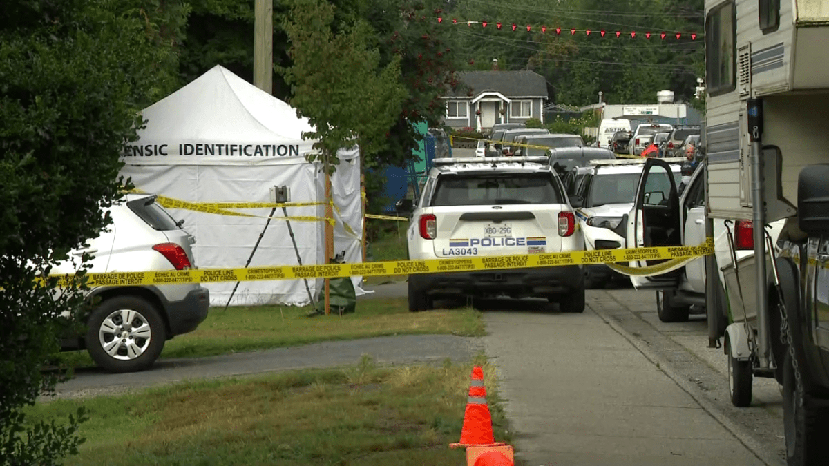 Crime scene tape up outside a home in the Aldergrove area of Langley after a person was found deceased in a truck in someone's driveway.