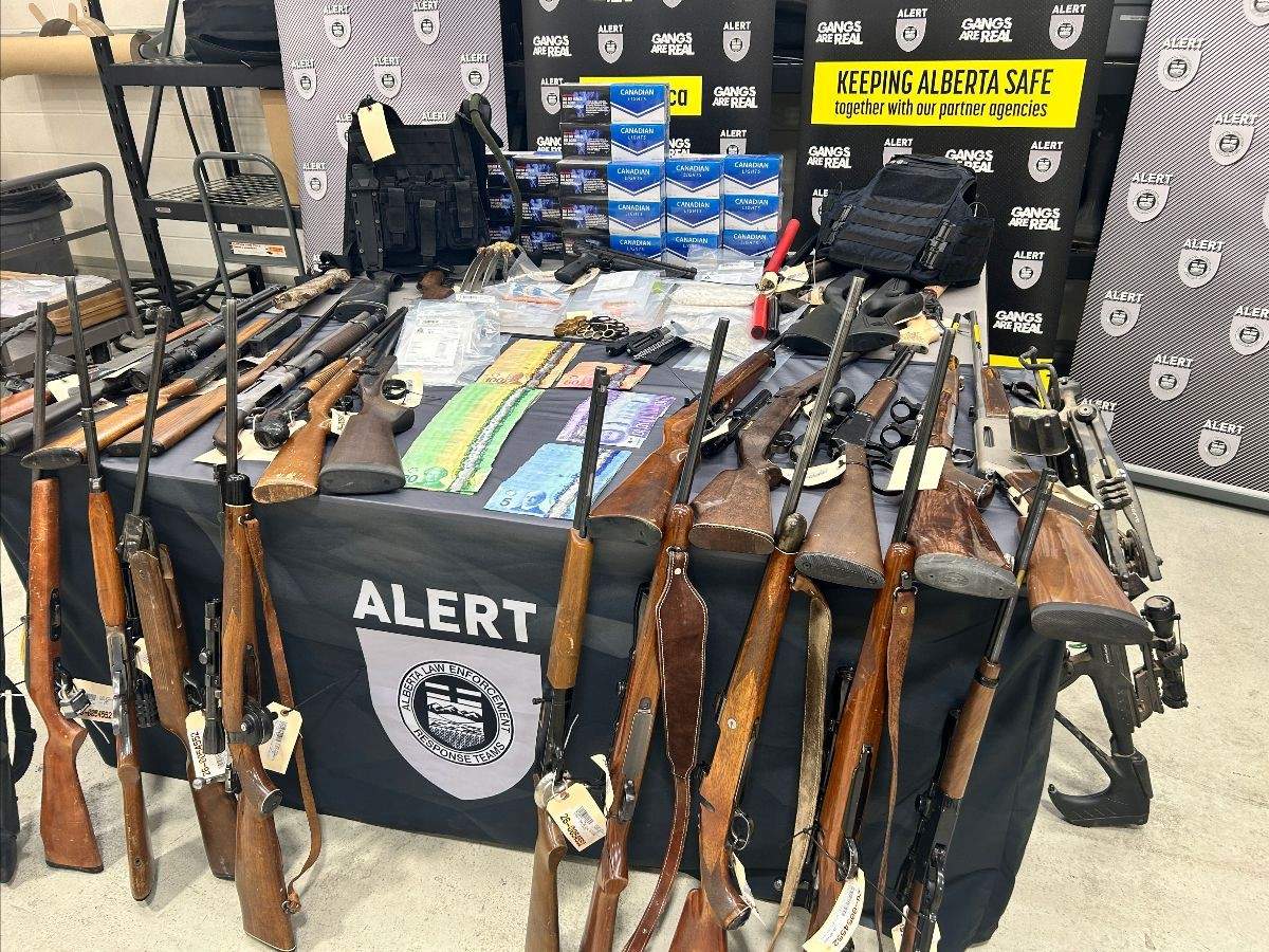 A photo provided by ALERT shows the large cache of weapons, drugs and cash, seized by police during an investigation into drug trafficking in Lethbridge.