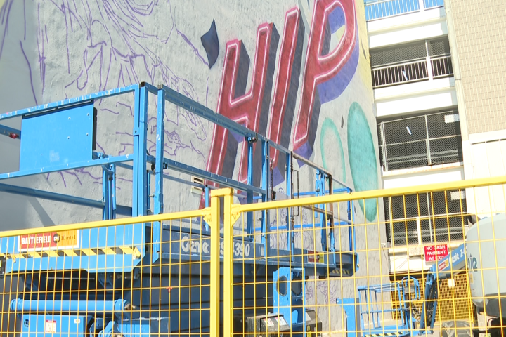 Three-storey Tragically Hip mural being painted in downtown Kingston
