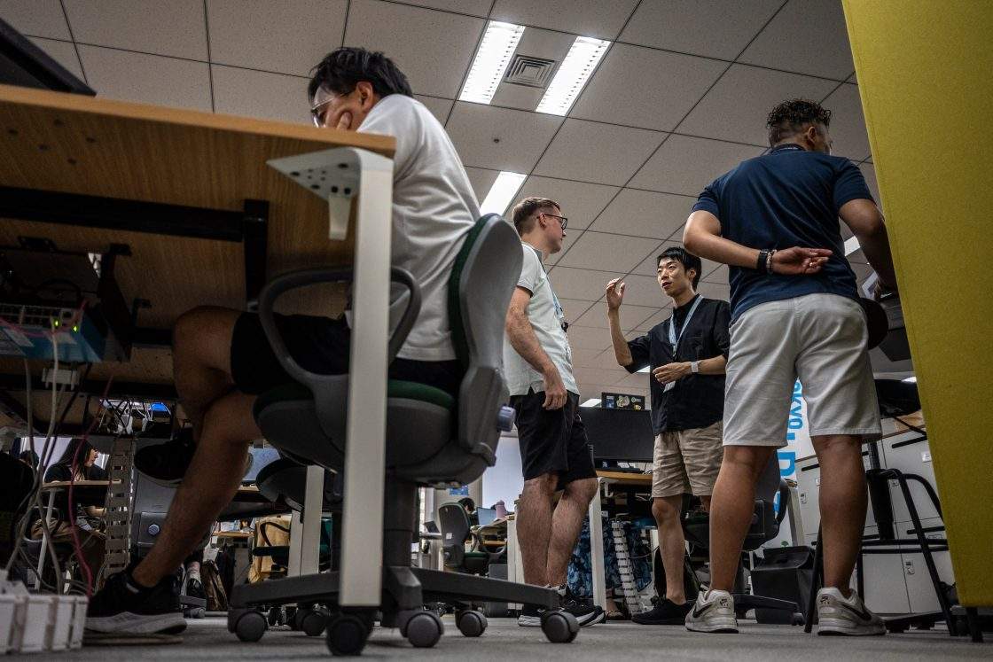 Government officials in casual dress code, including shorts, tee shirts and sneakers, work in the office of the Tokyo Metropolitan Government building, as part of the capital’s “Cool Biz” initiative, in Tokyo on July 14, 2026.
