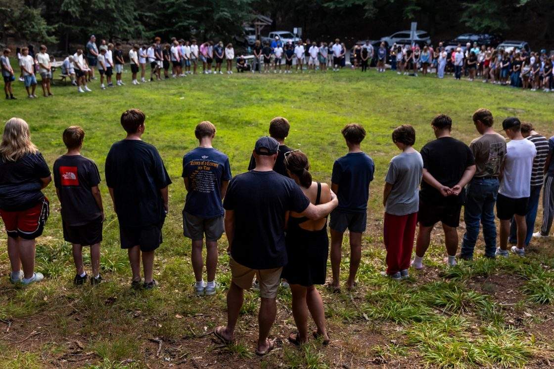 Community members gather during a student-organized vigil at Duncan Woods in Grand Haven, Mich., on July 26, 2026, to grieve and honour members of a local family who died in a tragedy that has stunned the lakeshore community.