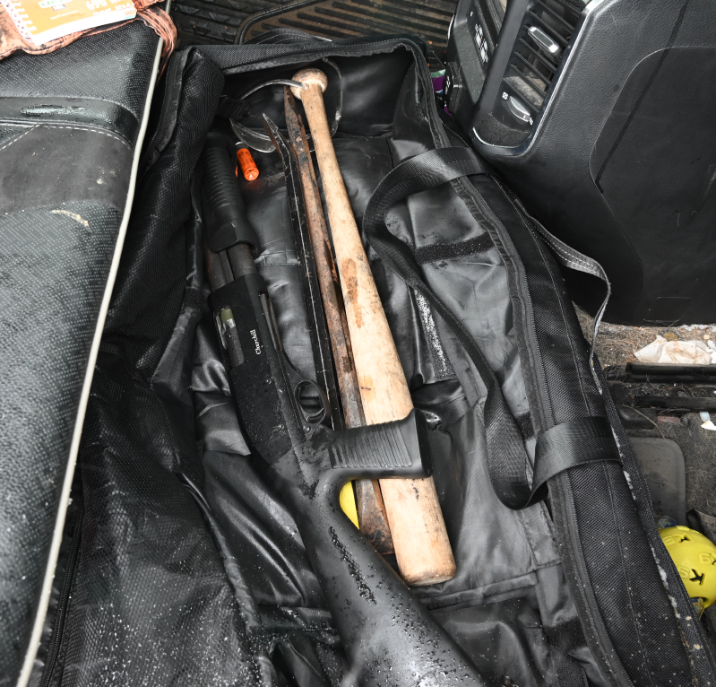 A baseball bat and one of many guns Calgary Police say were seized during the investigation into organized crime and drug trafficking.