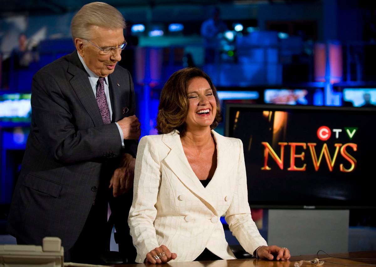 Lisa LaFlamme (right) sits in the anchor's chair as CTV announces that she will succeed Lloyd Robertson (left) as anchor of CTV News, in Toronto on Friday, July 9, 2010.