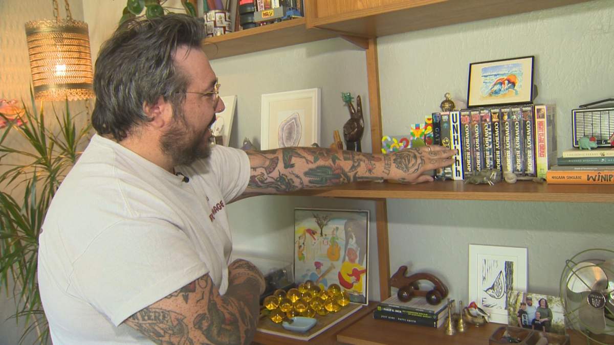 Wilson pointing to a box set of Cowboy Bebop, which he recently sold for $1,000.
