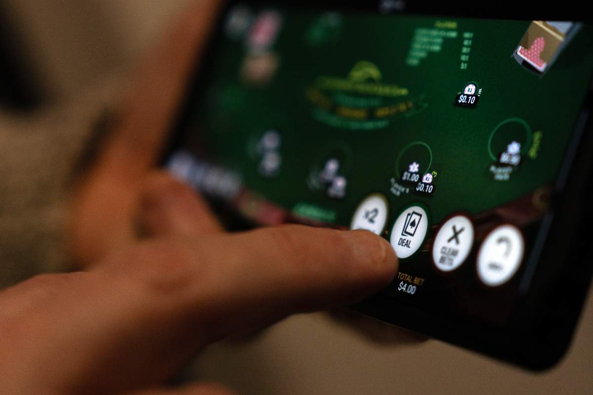 A "deal" button on a casino app in shown on a smartphone in a photo illustration made in Toronto on Wednesday, Jan. 17, 2024.
