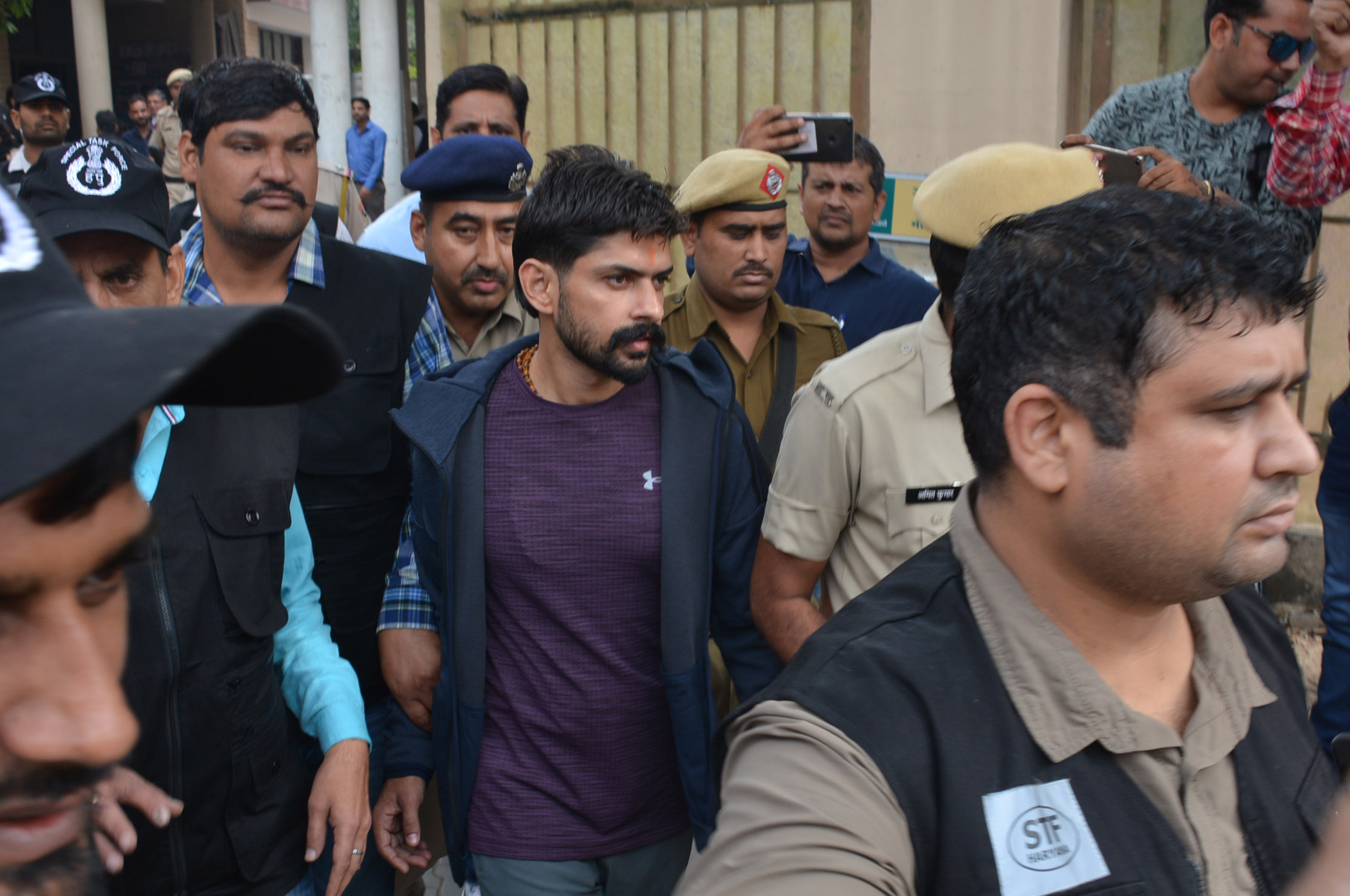 Despite being imprisoned in India since 2015, Lawrence Bishnoi, seen here in purple shirt, has overseen the expansion of his crime network into Canada. (Photo by Sant Arora/via Getty Images)
