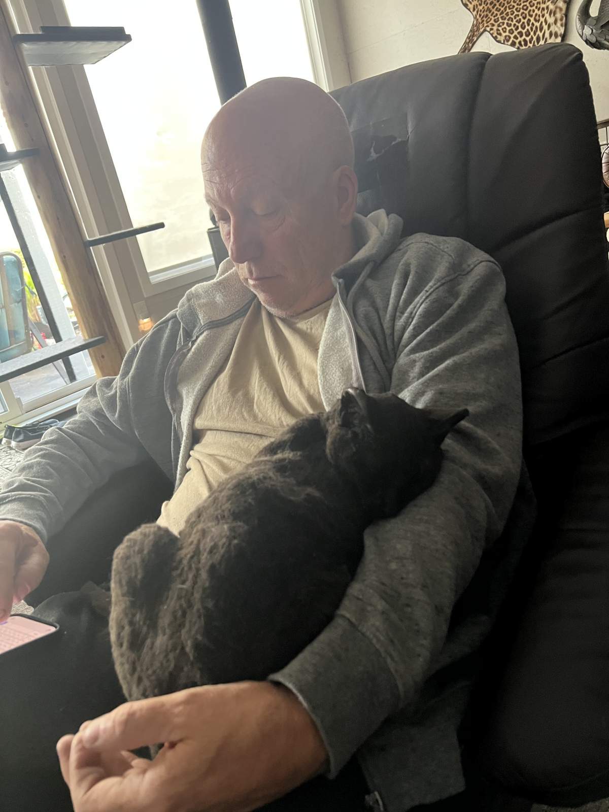 Andy Erickson and Lucky the cat during Luckys first night out of the fire