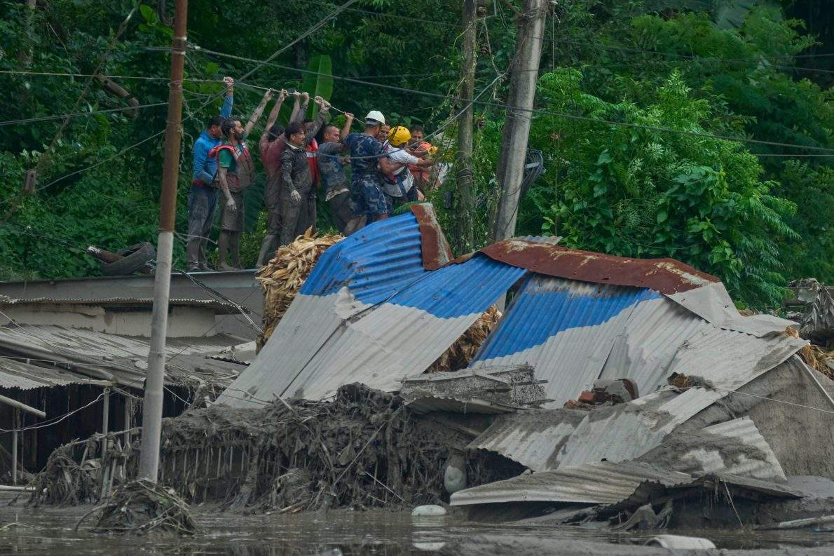 Rescuers lay a rope way to look for surivors after flash flooding along the Trishuli River in Nepal’s Nuwakot district, Wednesday, Aug. 26, 2026.
