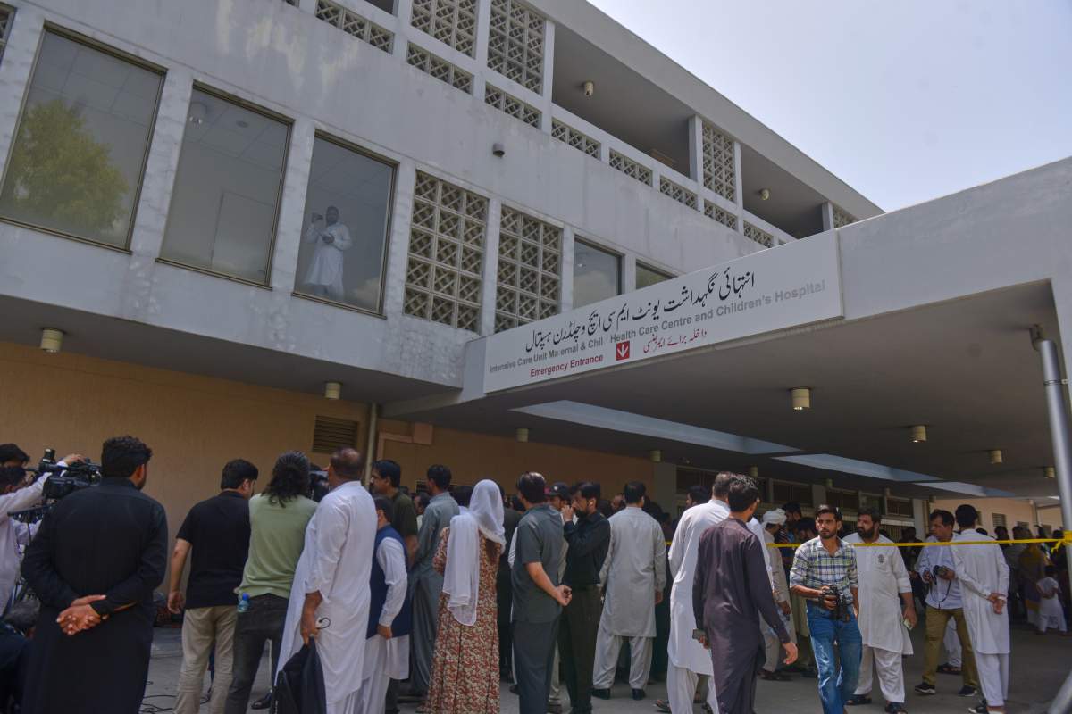 People gather outside a nursery in the gynecology ward following a fire at a hospital in Islamabad, Pakistan, Wednesday, Aug. 26, 2026. (AP Photo/M.A. Sheikh)