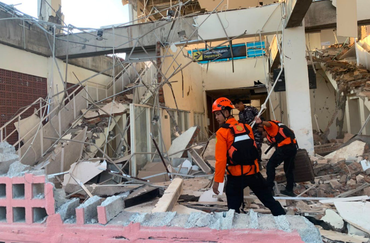 In this photo released by the Indonesian National Search and Rescue Agency (BASARNAS), rescuers search for victims at a damaged building following an earthquake in Maumere, East Nusa Tenggara Province, Indonesia, Saturday, Aug. 15, 2026.