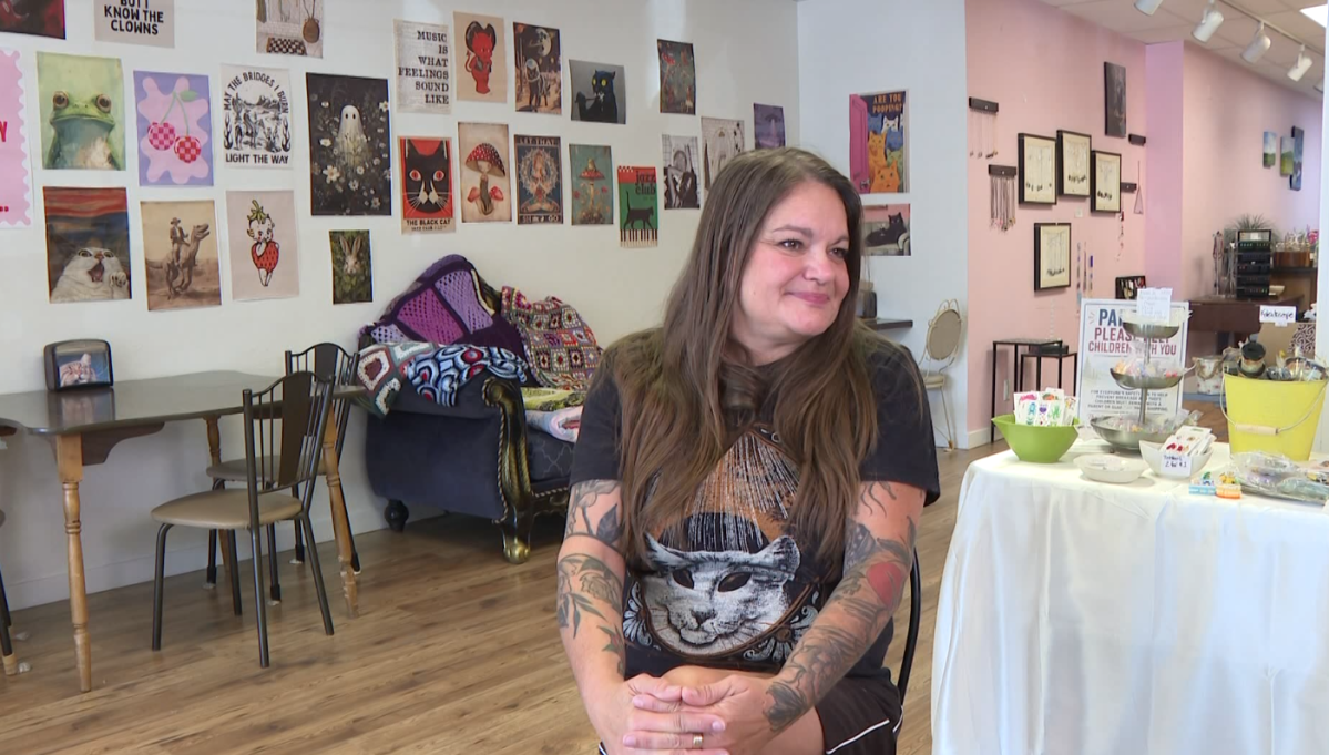 Jules Zest sitting in her thrift store/cafe. The store will be closing in December.