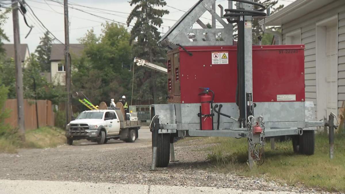 Workers fix telecommunications wires that were cut during attempted theft in Calgary's Dalhousie neighbourhood on Aug. 14, 2026.