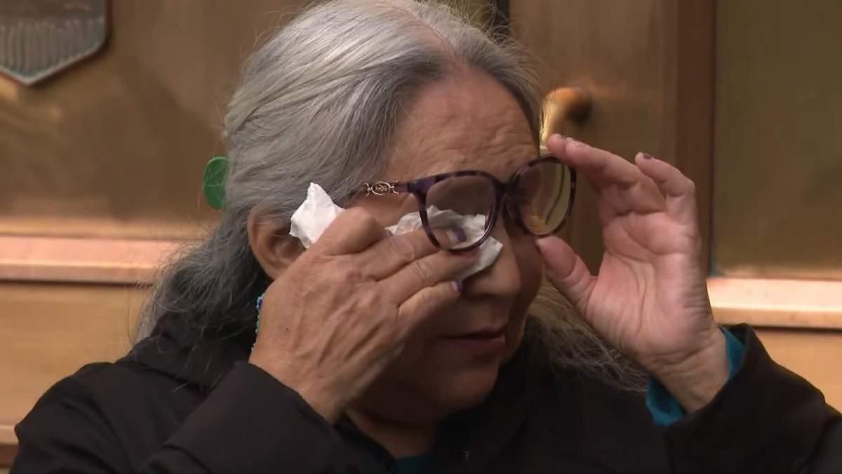 Levon Fox's mother, Lina Wildman, wipes away tears as she speaks to reporters outside the Calgary courthouse on Monday.